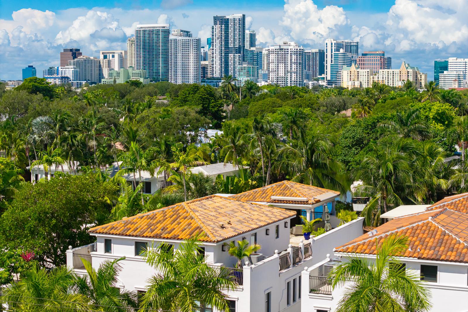 Aerial view of 411 Hendricks Isle with the Fort Lauderdale skyline behind it